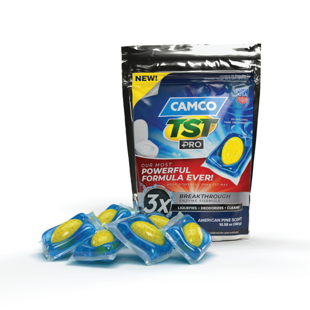 Package of CAMCO TST Pro RV toilet treatment with blue-yellow pouch design and several blue sachets with yellow disks nearby.