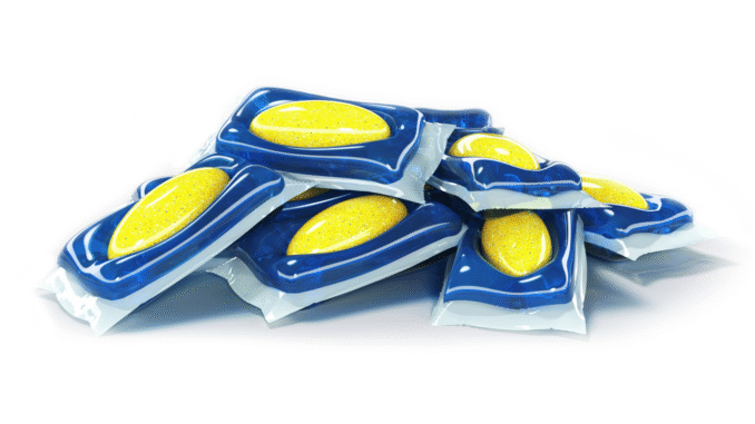 Pile of blue blister-pack tablets with yellow discs stacked on a white background
