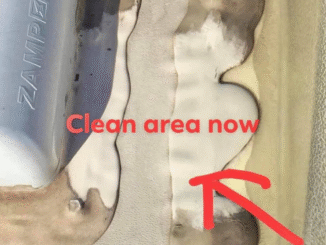 Close-up of a seam on a metal surface with beige sealant; a red arrow points to the area labeled 'Clean area now'.