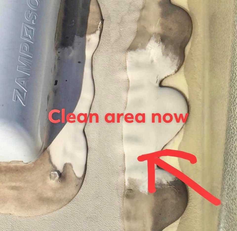 Close-up of a seam on a metal surface with beige sealant; a red arrow points to the area labeled 'Clean area now'.